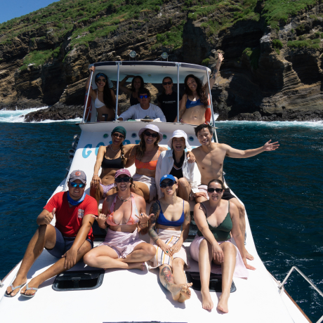 Happy group of travelers on a boat during a Galapagos freediving expedition